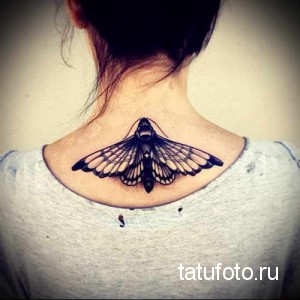 Фото тату мотылька на задней части шеи. Детализированный рисунок татуировки с проработанными крыльями.