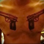 мужская татуировка два больших пистолета на груди -фото
