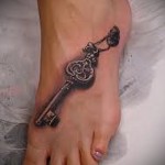 татуировка старинный ключик внизу ноги девушки