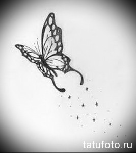 Фото тату черной бабочки с ажурными крыльями и рассыпающимися вокруг звездами. Минималистичный эскиз татуировки для запястья или щиколотки.
