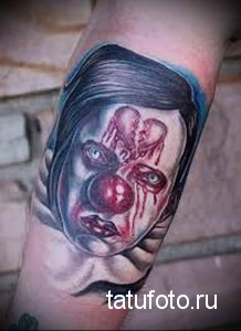 Фото тату плачущего клоуна на руке. Эмоциональный и реалистичный рисунок с красными слезами и грустным выражением лица. Подходит для тех, кто ценит глубину.