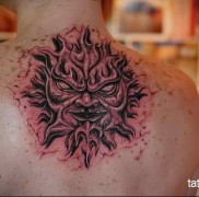 татуировка солнце — с мордой демона — пылающий и страшный рисунок
