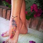 цветное тату с пером внизу ноги для девушки фото