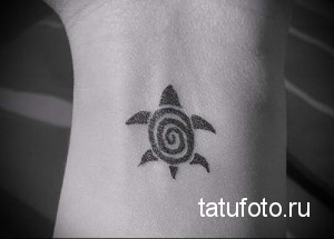 Фото тату маленькой черной черепахи на запястье. Простой и лаконичный рисунок татуировки в стиле минимализм. Идеальный эскиз тату для начинающих.