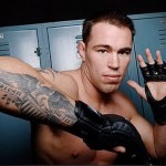 Фото татуировки орла на руке спортсмена MMA. Детализированный рисунок, реалистичный стиль, американская символика.