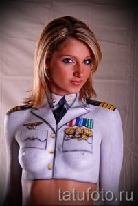Фото боди-арта: девушка, изображающая военный мундир, реалистичный рисунок, детализированные элементы, строгий стиль, нейтральные цвета.