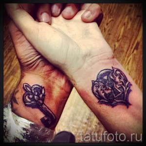 Фото парных татуировок на запястьях: стилизованный ключ и замок. Черно-серый рисунок татуировки, символизирующий любовь и верность.