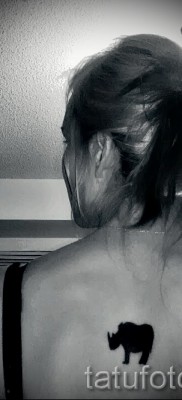 Фото пример тату носорог — черная маленькая тату на спину для девушки