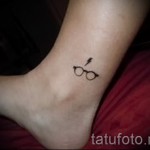 small tattoo on his ankle - an example of the photo 2