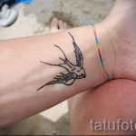 swallow tattoo on her wrist - Photo example 1