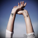 swallow tattoo on her wrist - Photo example 4