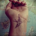 swallow tattoo on her wrist - Photo example 5