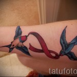 swallow tattoo on her wrist - Photo example 7