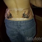 swallow tattoo on his back - a photo example 4