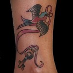 swallow tattoo on his leg - an example of the photo 1