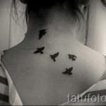 swallow tattoo on his neck - Photo example 2