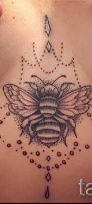 Пример тату пчелы на фото — вариант между грудей у молодой красивой девушки
