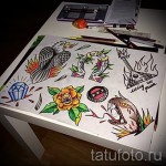 Фотография набора эскизов татуировок, включающего изображения алмазов, орла, розы, гитары и других символов.