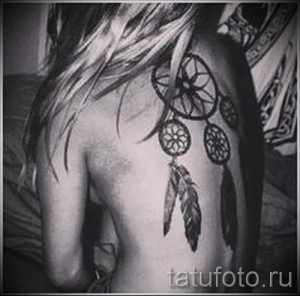 Фото тату: Несколько ловцов снов с перьями на спине девушки. Черно-белый рисунок татуировки, выполненный опытным мастером тату.