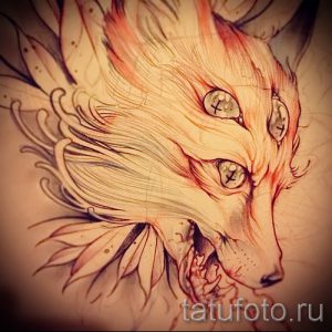 Эскиз татуировки лисьей головы с мистическим эффектом. Рисунок выполнен в мягких тонах с использованием плавных линий и эффекта свечения, создающих загадочную атмосферу.