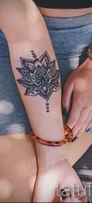 value lotus tattoo on the arm of the girl 1