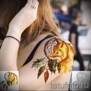 Фото тату лисы с ловцом снов, выполненное в акварельной технике. Нежные цвета и плавные переходы создают романтичное настроение.