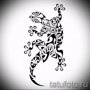 Фото тату геккона в стиле трайбл, выполненное в черном цвете. Рисунок состоит из сложных геометрических узоров и орнаментов.
