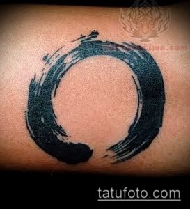 Фото татуировки: тату в стиле энсо (Zen circle) на предплечье. Черный круг, нарисованный одним мазком, символизирует просветление и вселенную.