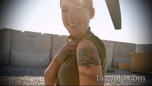 Фото тату на плече с изображением солдата с американским флагом и надписью 'I am a U.S. Marine'. Цветной рисунок татуировки.
