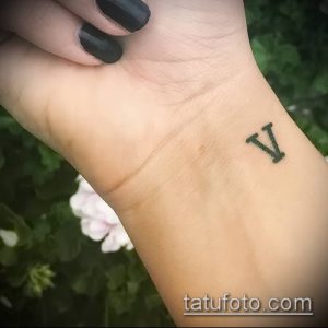 Фото тату: Небольшая татуировка с римской цифрой 'V' на запястье. Простой и элегантный дизайн.