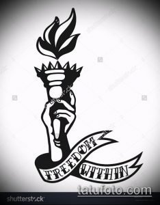 Фото тату в стиле blackwork с изображением руки, держащей факел, и надписью 'FREEDOM WITHIN'.