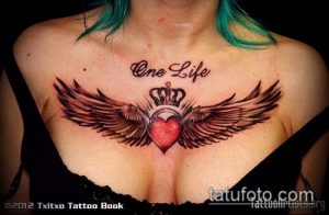 Фото тату сердца с крыльями и короной, надписью 'One Life' на груди. Черно-серая татуировка с детальной проработкой.