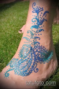 Фото тату мехенди на лодыжке. Узор, выполненный хной с добавлением блесток, создает эффект мерцания. Идеально для праздничного образа.