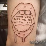 Фото татуировки на руке, изображающей губы с надписью "What's love got to do with it?"