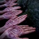Фото тату хной на ладонях нескольких людей, изображающее змей. Оригинальный и запоминающийся рисунок.