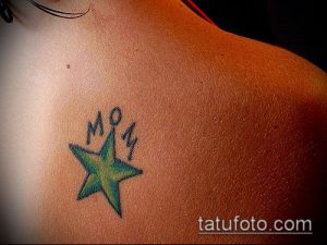 Фото тату: простая зеленая звезда с надписью 'MOM' на плече, выполненная в минималистичном стиле.