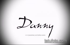 Черно-белое фото татуировки с именем "Danny", выполненной простым, но стильным шрифтом. Подходит для вдохновения мужских татуировок.