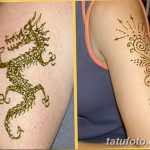 Фотография татуировки дракона, выполненной хной на руке и предплечье. На одном предплечье изображен дракон, на другом - солнечные узоры.