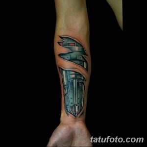 Фото тату шлема космического десантника в стиле sci-fi на предплечье. Рисунок выполнен в ярких цветах с детальной проработкой элементов.