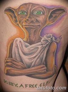 Colorful tattoo of Dobby the House Elf from Harry Potter, with a cheerful expression and the inscription 'Dobby, a Free Elf'.