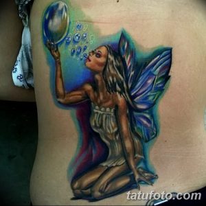 Realistic color tattoo of a beautiful fairy blowing bubbles on a woman's side, with delicate wings and flowing hair, showcasing vibrant colors.