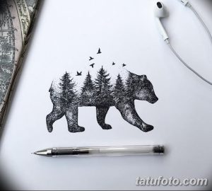 Эскиз татуировки с изображением медведя, внутри которого находится лесной пейзаж. Оригинальная и символичная идея для любителей дикой природы.