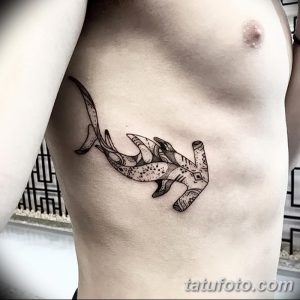 Фото тату акулы-молота в технике дотворк на груди. Черно-белый рисунок, точечные узоры, минимализм.