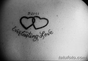 Фотография татуировки с надписью 'Everlasting Love', двумя сердцами и датой '5-21-11'. Черно-белый рисунок.