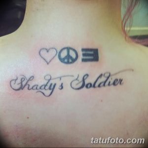 Фото татуировки на груди, изображающей надпись «Shady’s Soldier» и символы сердца, мирного знака и эмблемы.