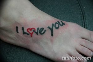 Небольшая татуировка на стопе с надписью 'I Love You', где буква 'O' заменена на сердце. Романтичный и нежный рисунок.