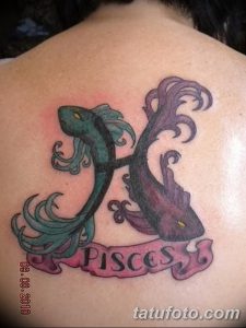 Фото татуировки на спине с изображением знака зодиака Рыбы и надписью 'Pisces'. Рисунок выполнен в ярких, пастельных тонах.
