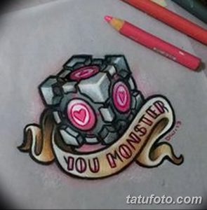 Фото тату с изображением Companion Cube из игры Portal 2 и надписью "You Monster". Милый и ироничный дизайн.