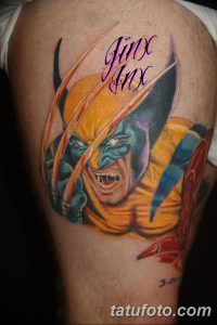 Фото тату Росомахи с надписью "Jinx" на плече. Яркий рисунок с использованием желтых, синих и красных оттенков.