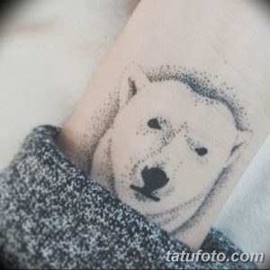 Фото татуировки головы белого медведя, выполненной в технике pointillism. Изображение состоит из множества точек, создающих эффект текстуры и объема.